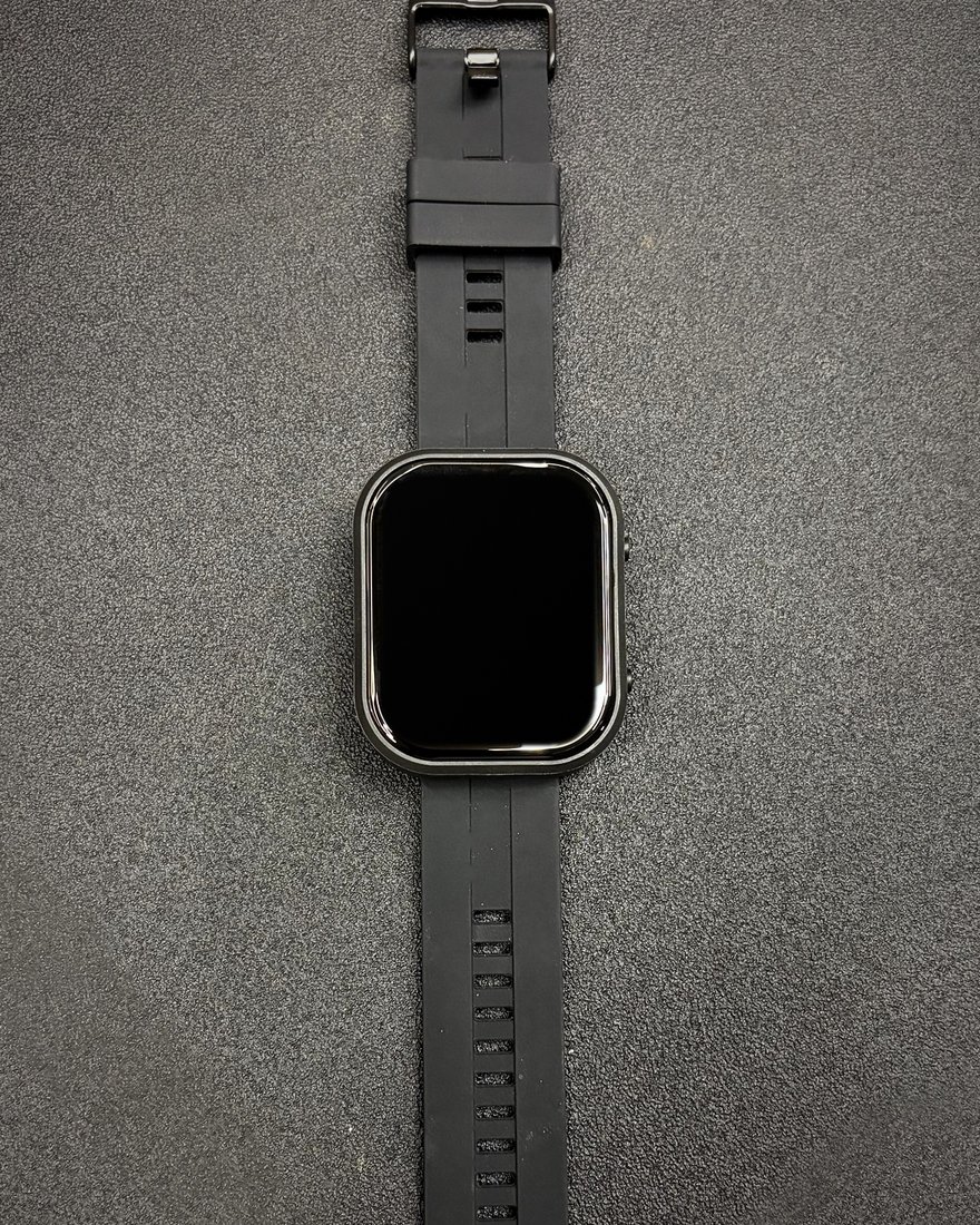 A PitchKallr Watch laid flat with its black silicone strap extended.